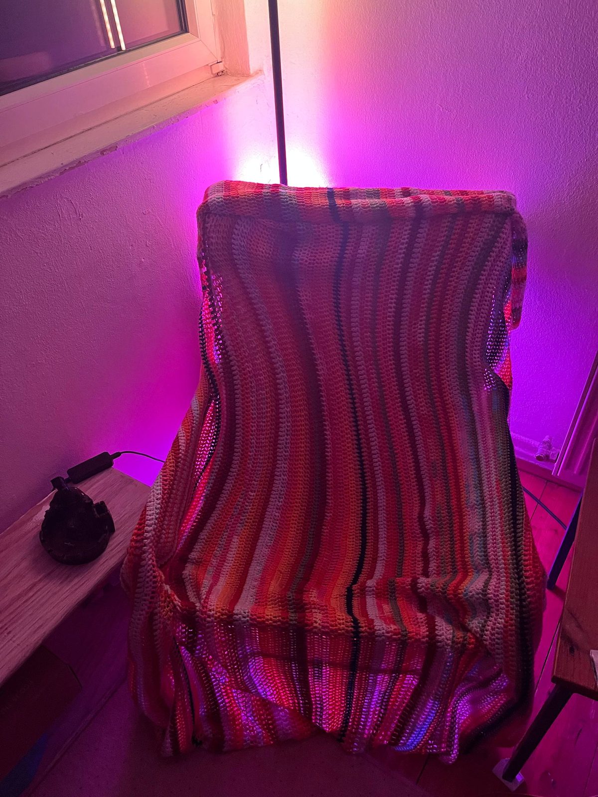 A corner of the studio lit in deep magenta during a sound session.